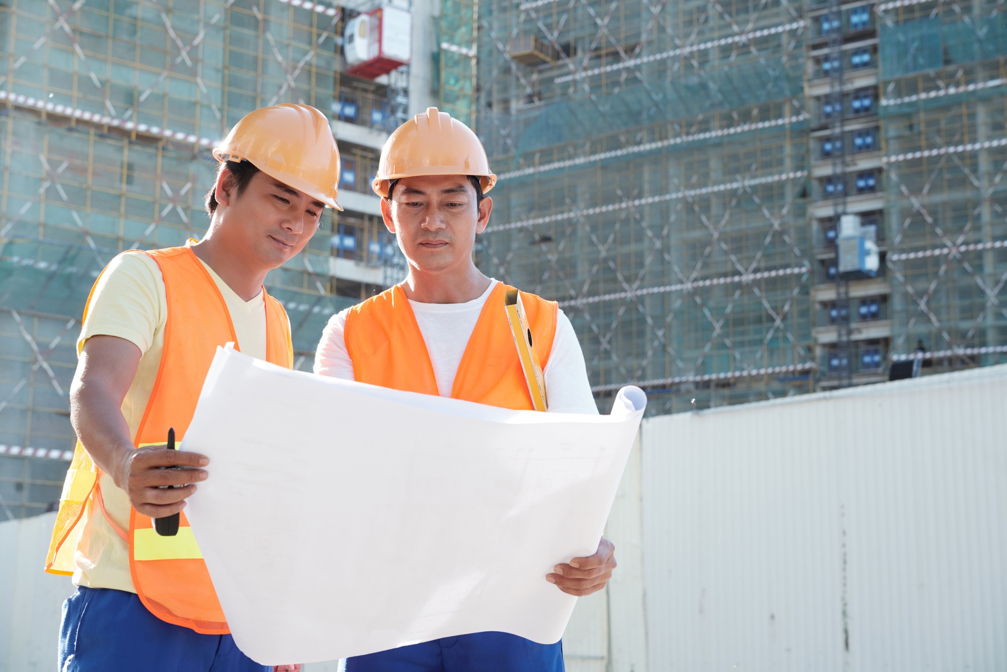 Construction Workers Discussing Building Plan